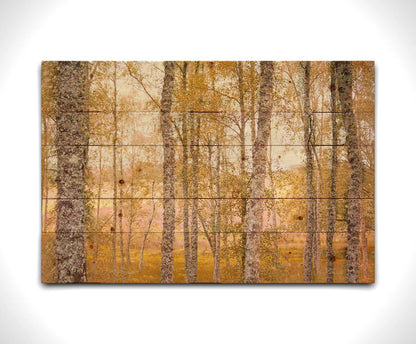 A landscape photo of a forest of yellow autumn trees, edited to be reminiscent of pointilism. Printed on a wood pallet.