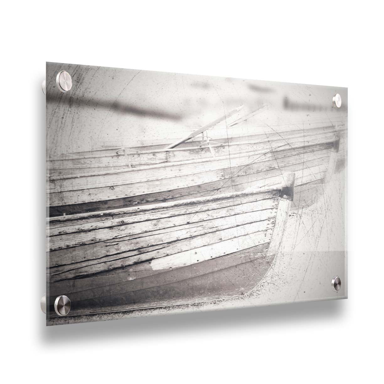 A grayscale photo of two rowboats on the sand. It is overlayed with a scratchy weathered texture. Printed on acrylic.