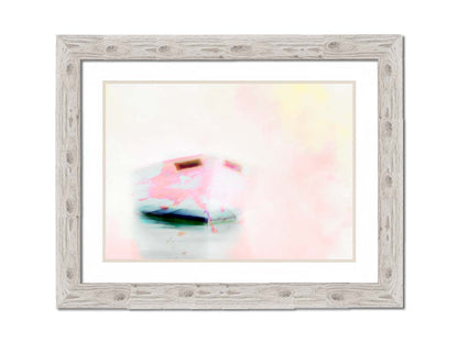 A photo of a small boat on the water, drastically edited for a white, high contrast look and textured with faint pinks and yellows. Printed on paper, matted, and framed.