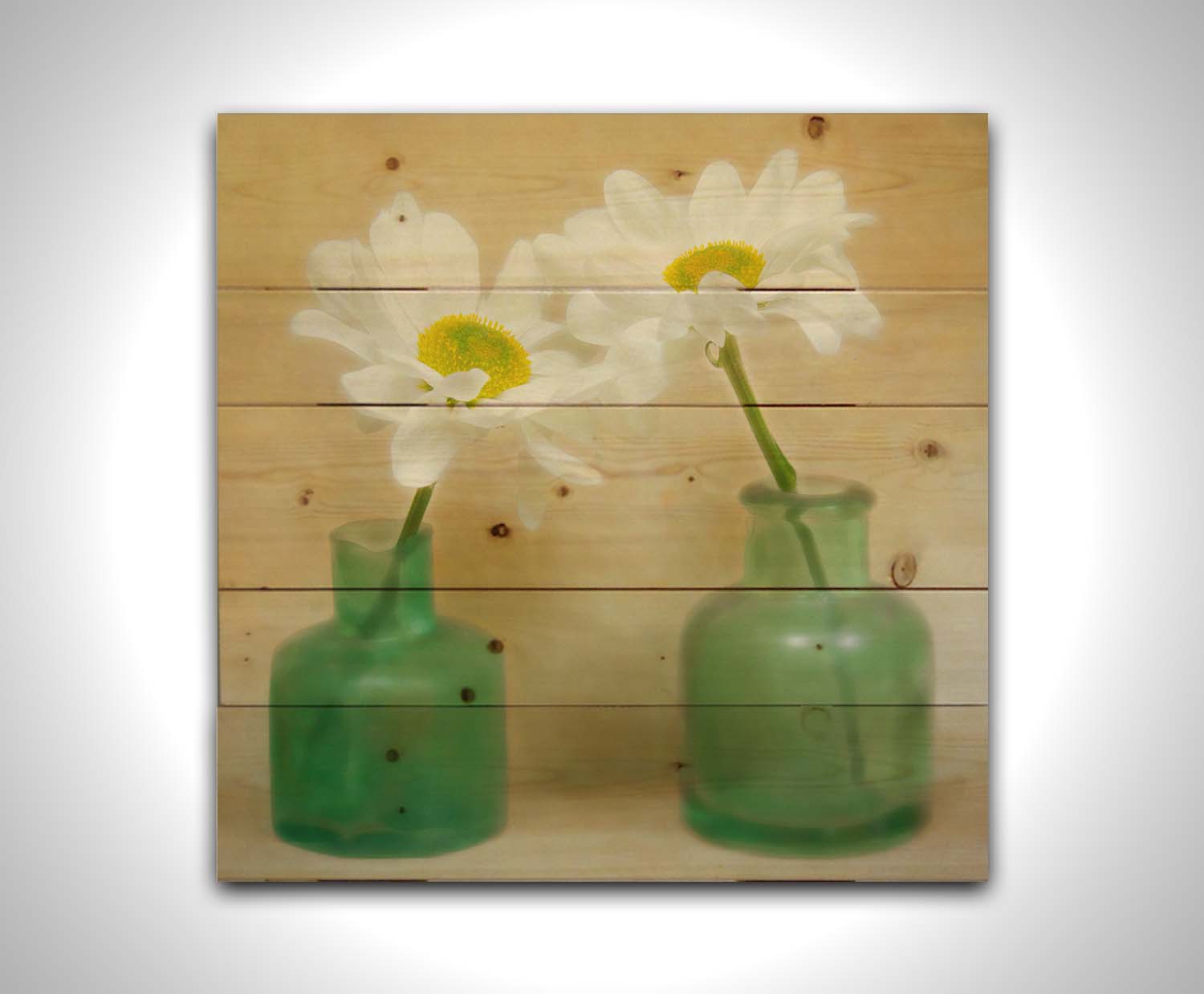 A photo of two white flowers in green glass jars, sitting against one another against a tan backdrop. Printed on a wood pallet.