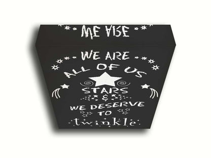 A typography design reading "We are all of us stars and we deserve to twinkle" in white on a black background. Printed on canvas.