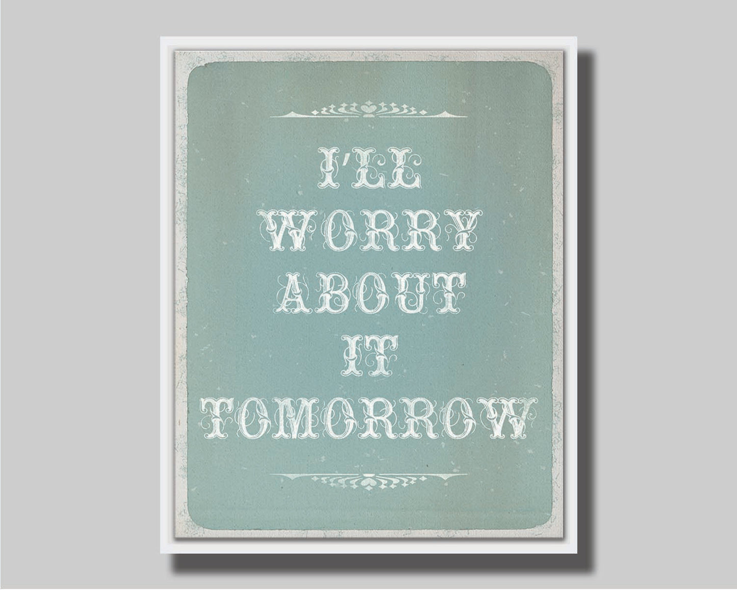 A typography design reading "I'll worry about it tomorrow" in white on a pale blue background. Printed on canvas in a float frame.