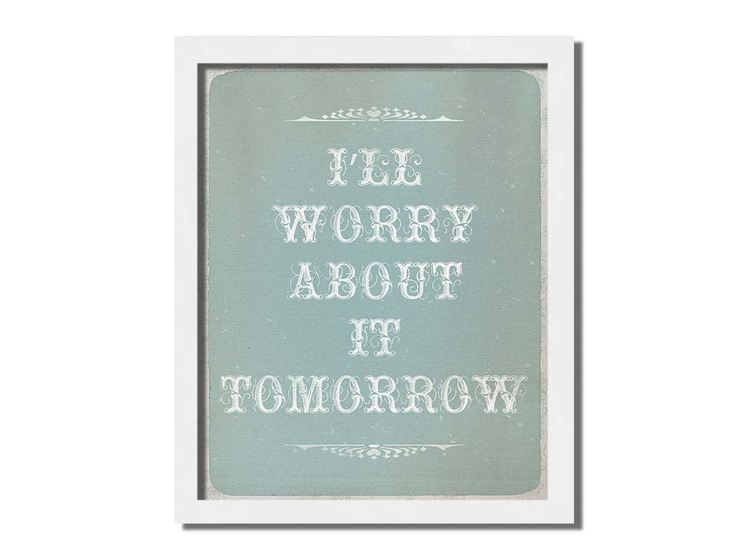 A typography design reading "I'll worry about it tomorrow" in white on a pale blue background. Printed on canvas and framed.