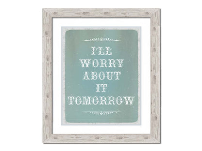 A typography design reading "I'll worry about it tomorrow" in white on a pale blue background. Printed on paper, matted, and framed.