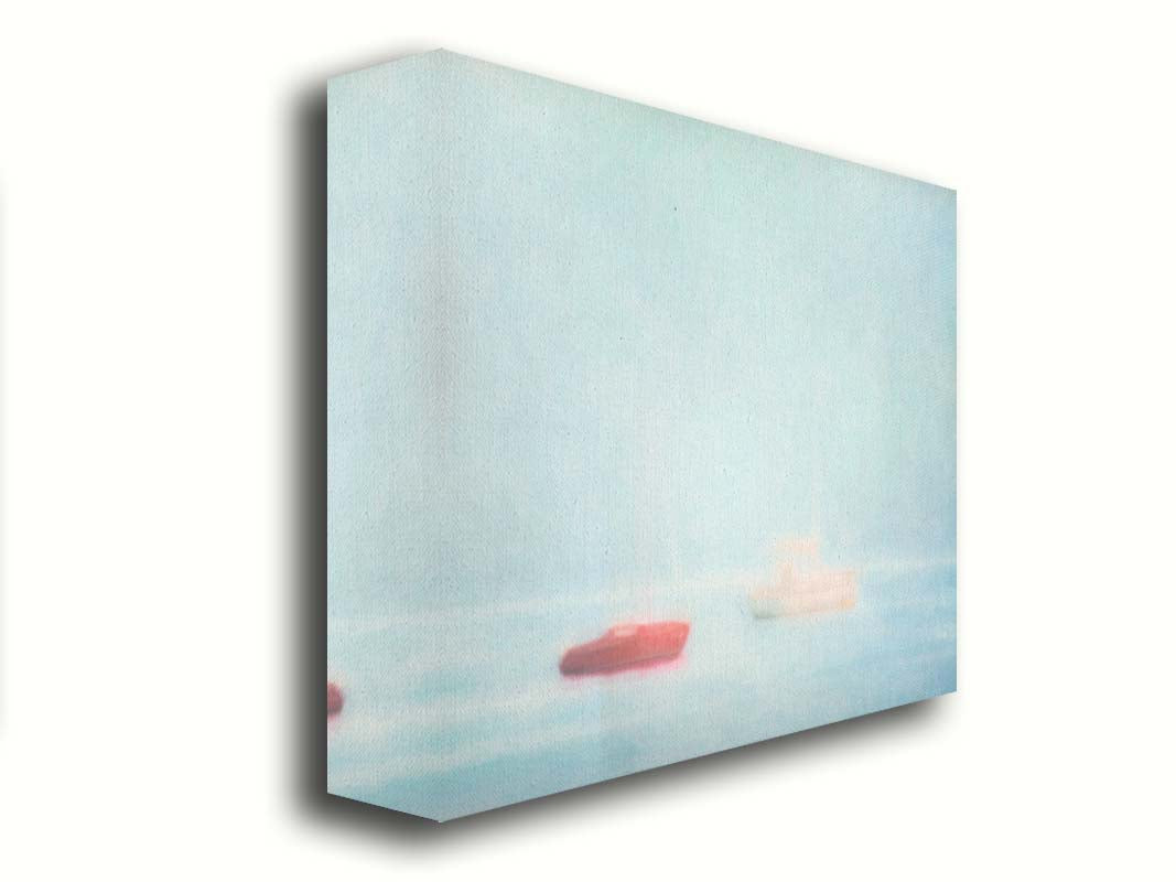 A photo of a small red boat and a small white and yellow boat floating at sea. The photo is edited to have a soft, blurry quality which blends the sky and sea together on the horizon. Printed on canvas.