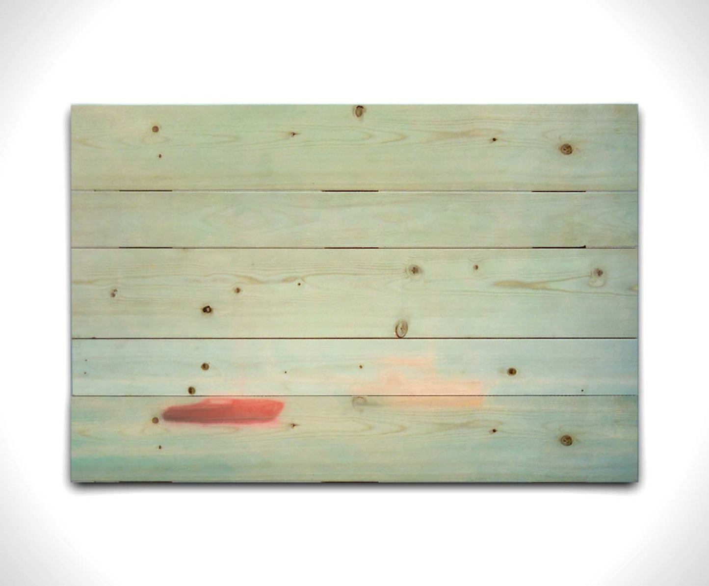 A photo of a small red boat and a small white and yellow boat floating at sea. The photo is edited to have a soft, blurry quality which blends the sky and sea together on the horizon. Printed on a wood pallet.