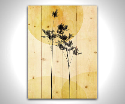 A photo edit of silhouetted palm plants against a yellow bokeh background with a watercolor paper texture. Printed on a wood pallet.