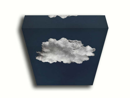 A photo edit of a large, fluffy white cloud against a deep blue background. Printed on canvas.