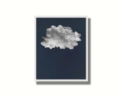 A photo edit of a large, fluffy white cloud against a deep blue background. Printed on canvas in a float frame.