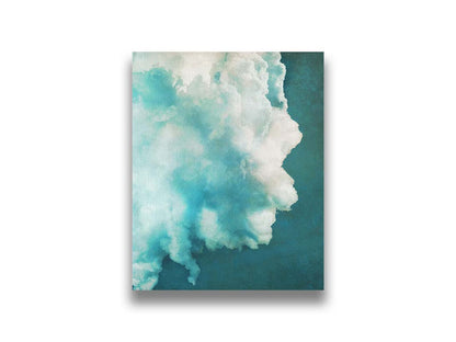 A photograph of a big white cloud with a teal background. Printed on canvas.