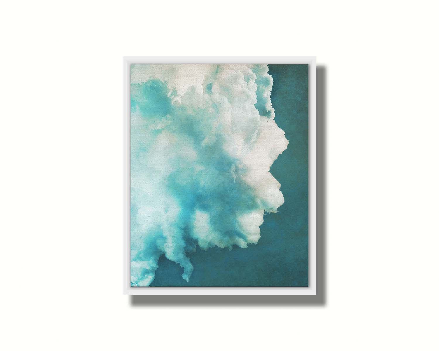 A photograph of a big white cloud with a teal background. Printed on canvas in a float frame.