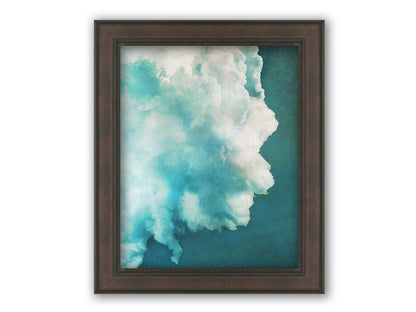 A photograph of a big white cloud with a teal background. Printed on canvas and framed.