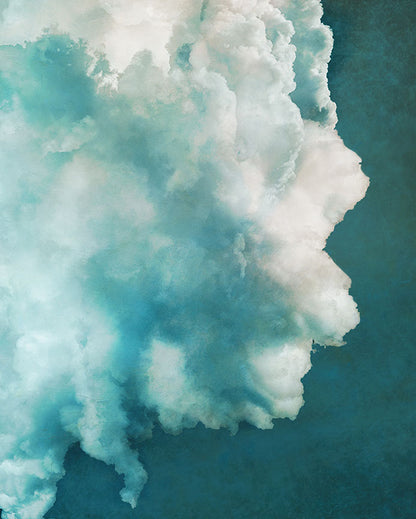 A photograph of a big white cloud with a teal background.