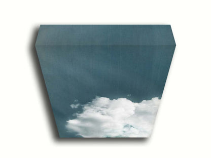 An edited photo of a soft white cloud against a steely blue background. Printed on canvas.