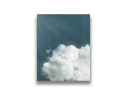 An edited photo of a soft white cloud against a steely blue background. Printed on canvas.