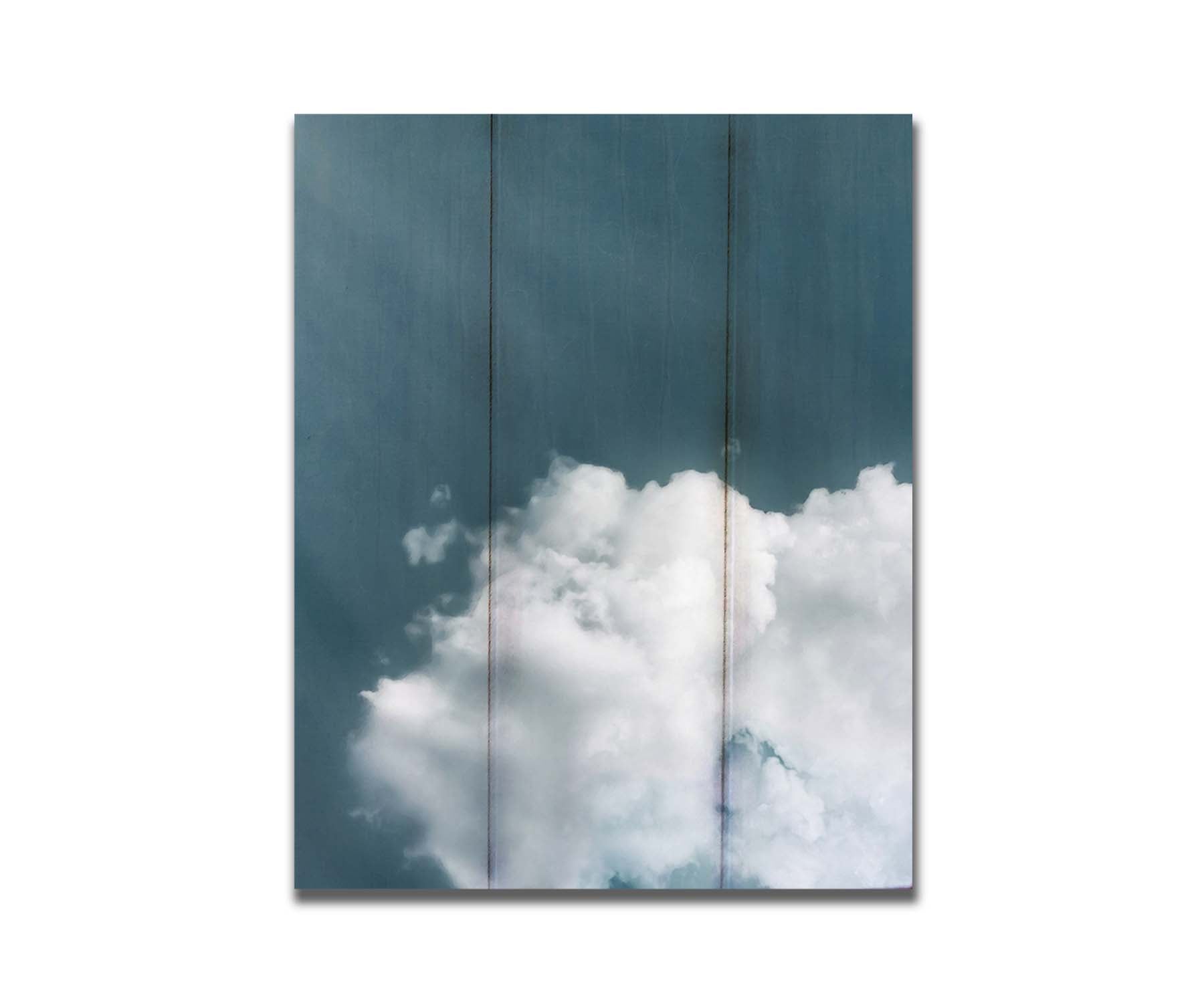 An edited photo of a soft white cloud against a steely blue background. Printed on a box board.