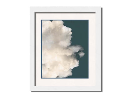 An edited photo of a soft white cloud against a blue background. Printed on paper, matted, and framed.