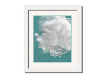 An edited photo of a soft white cloud against a turquoise blue background. Printed on paper, matted, and framed.