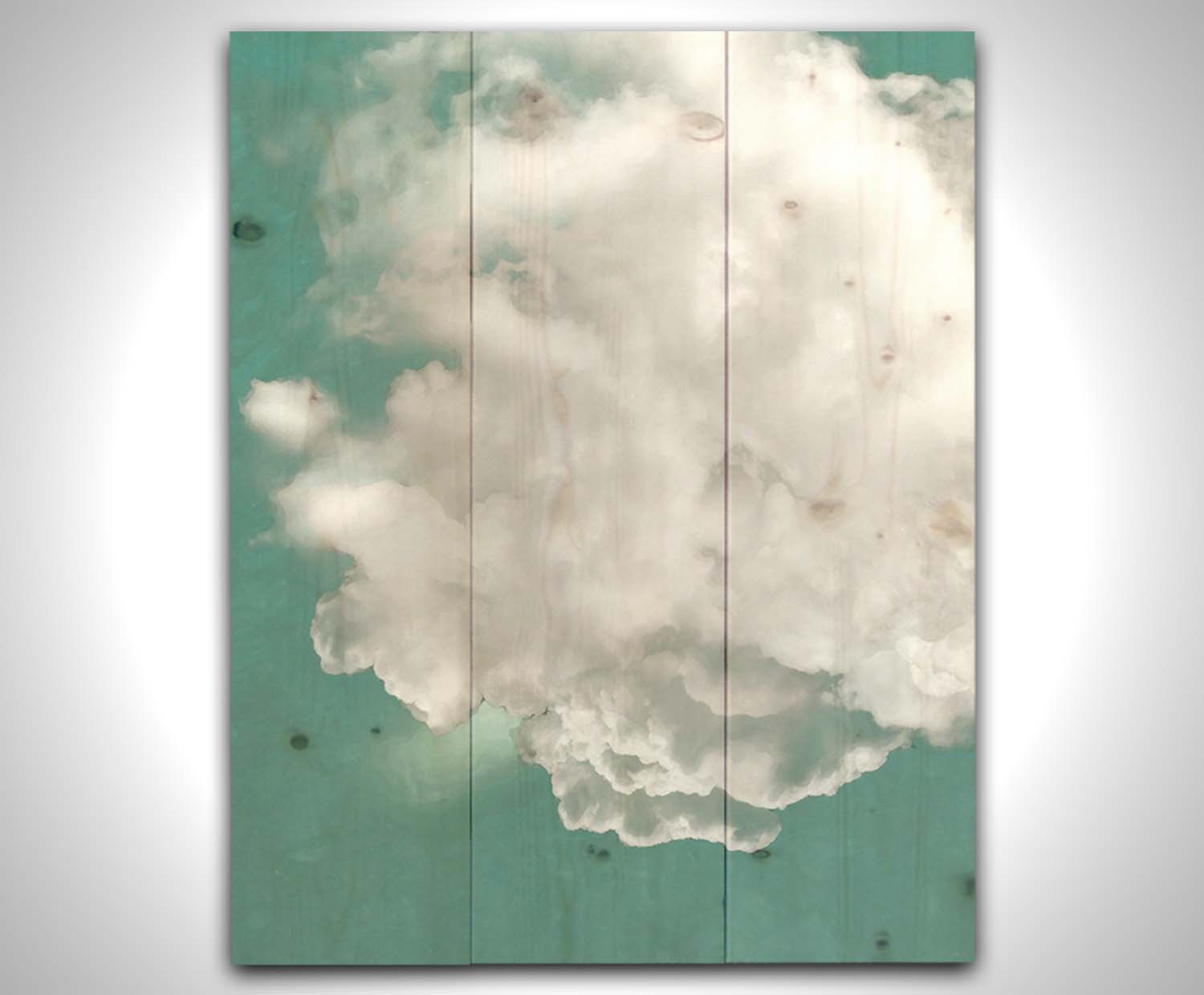 An edited photo of a soft white cloud against a turquoise blue background. Printed on a wood pallet.