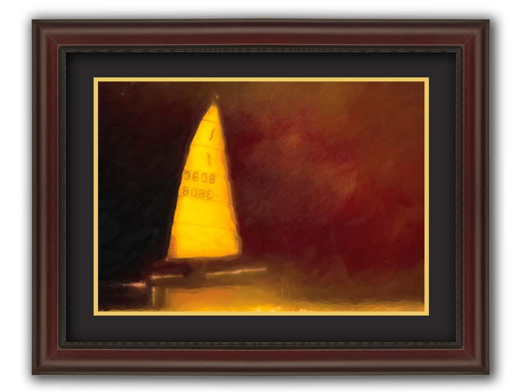 An edited photograph of a sailboat on the water, surrounded by a rusty red and bright yellow color palette, with an added painterly texture. Printed on paper, matted, and framed.