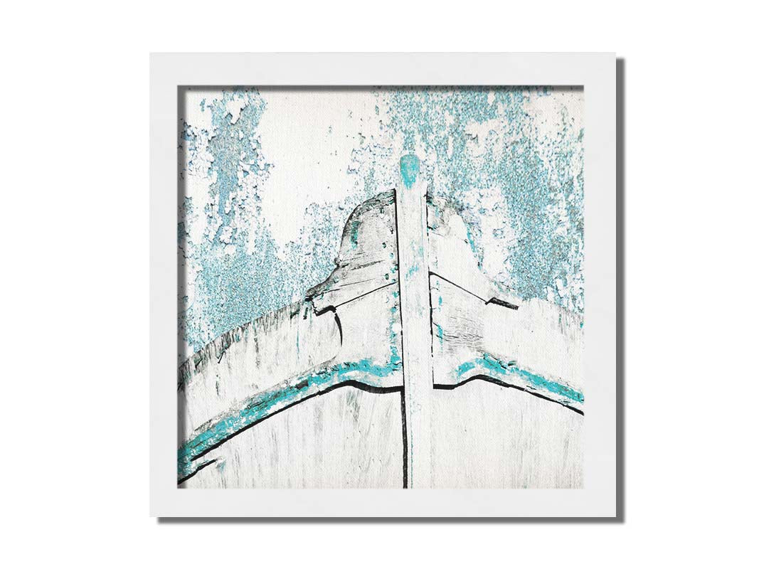 A photograph of an old boat bow in a white and turquoise palette. Printed on canvas and framed.