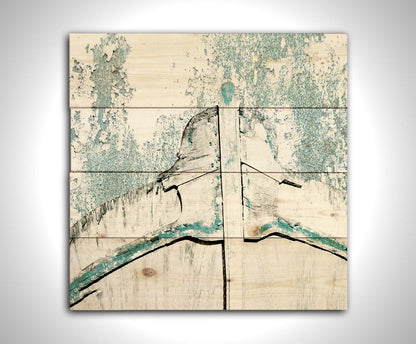 A photograph of an old boat bow in a white and turquoise palette. Printed on a wood pallet.