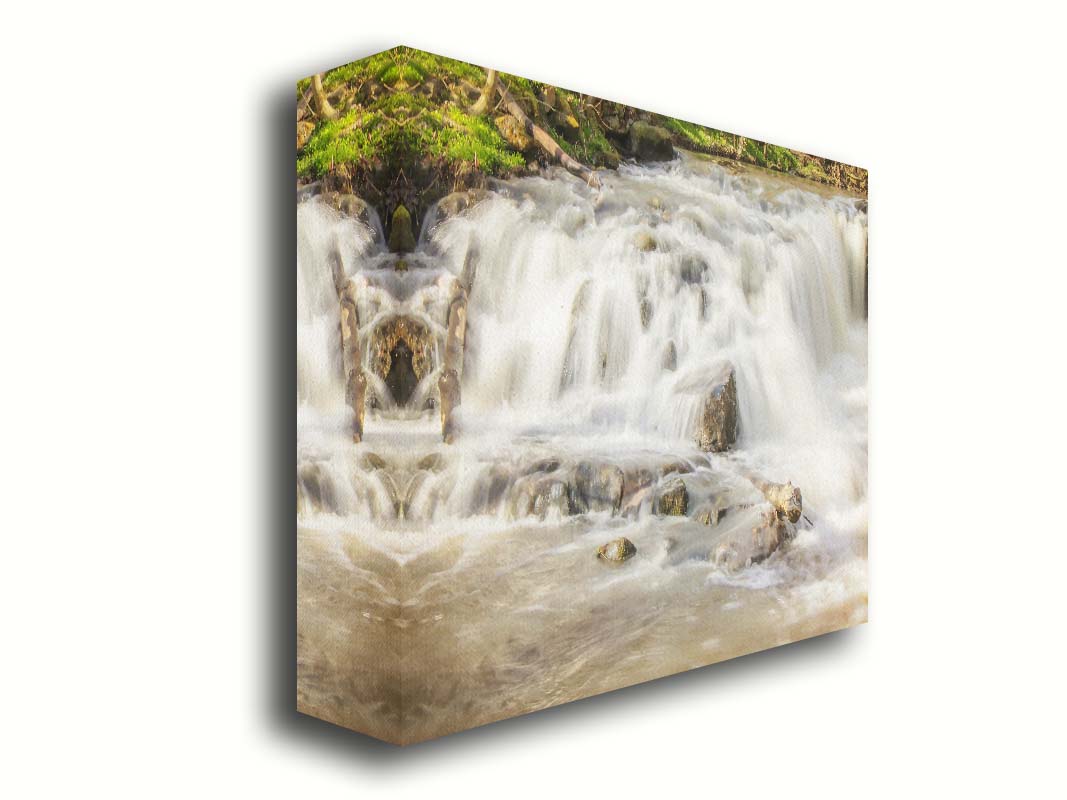 A photograph of a small river waterfall, only a few feet high. The use of a slow shutter speed technique gives the water a soft, gentle appearance. Printed on canvas.