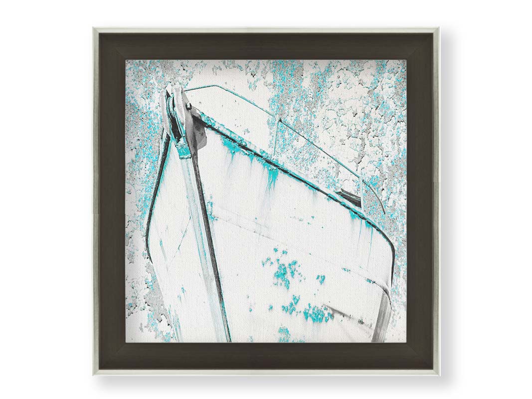 A photograph of an old boat in a white and turquoise palette. Printed on canvas and framed.