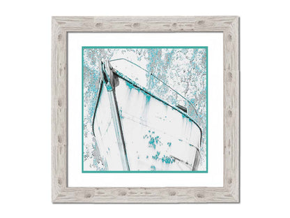 A photograph of an old boat in a white and turquoise palette. Printed on paper, matted, and framed.