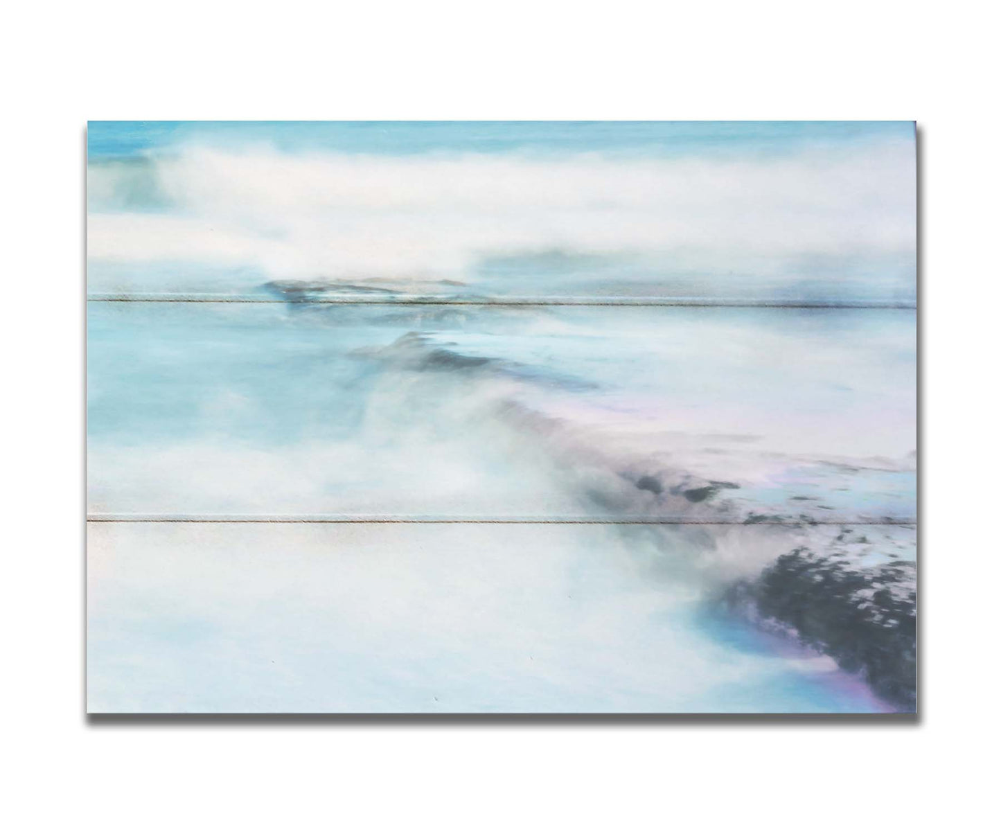 A photograph of a battered jetty being washed over by incoming waves in a cool, white and blue palette. Printed on a box board.