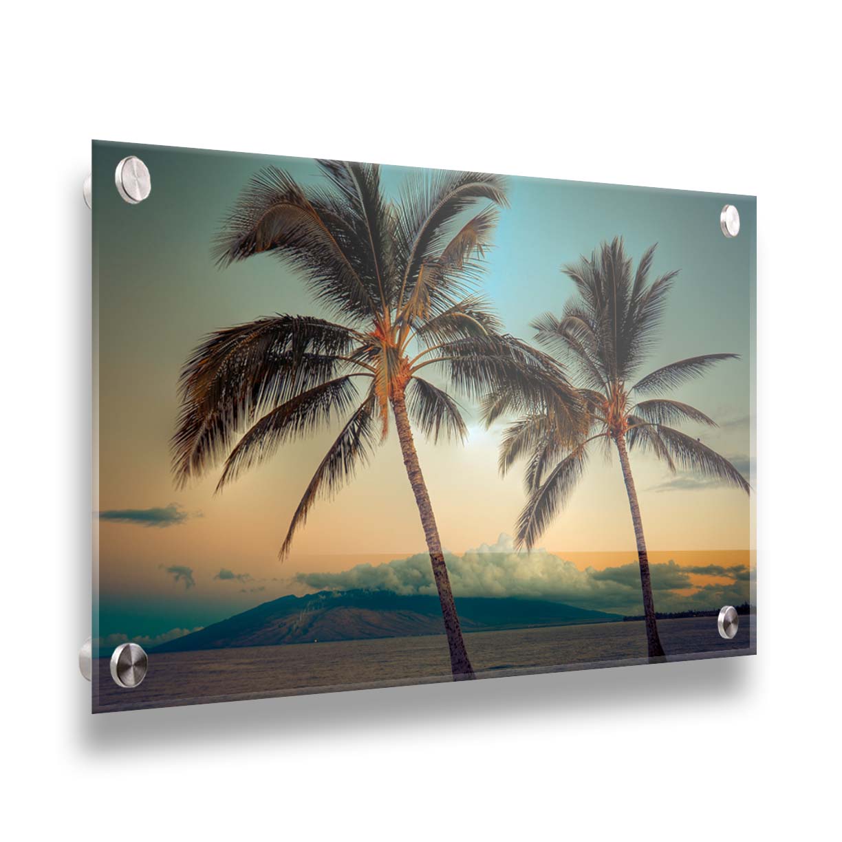 A photo of two palm trees in Maui at sunset, with the sea and cloud-topped mountains in the background. Printed on acrylic.