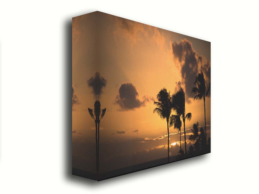 A photo of palm trees in Maui silhouetted by the setting sun, with the sea in the background. Printed on canvas.