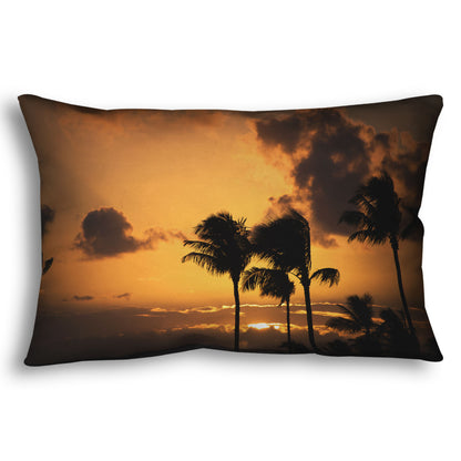 A throw pillow designed with a photo of palm trees in Maui silhouetted by the setting sun, with the sea in the background.