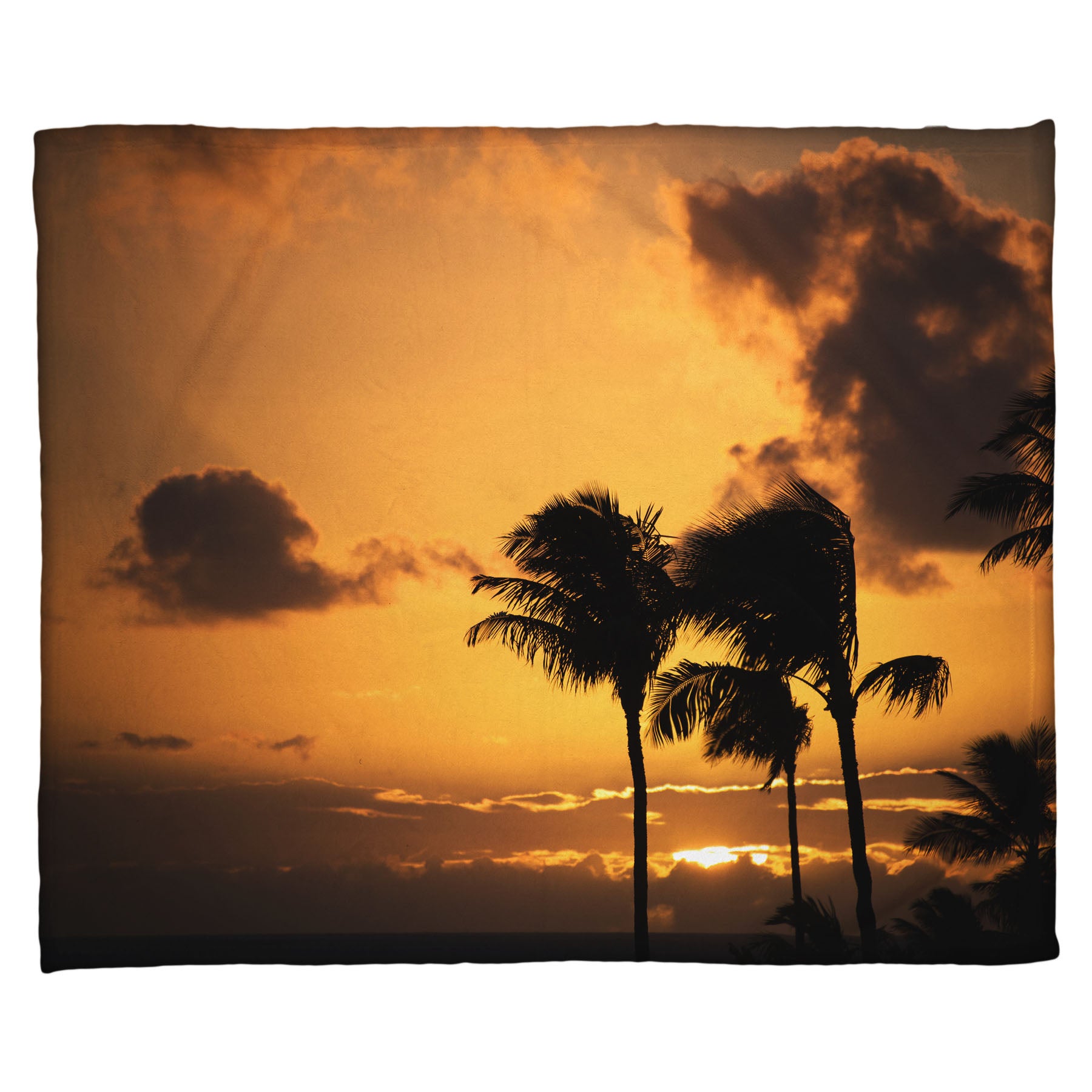 A coral fleece blanket designed with a photo of palm trees in Maui silhouetted by the setting sun, with the sea in the background.