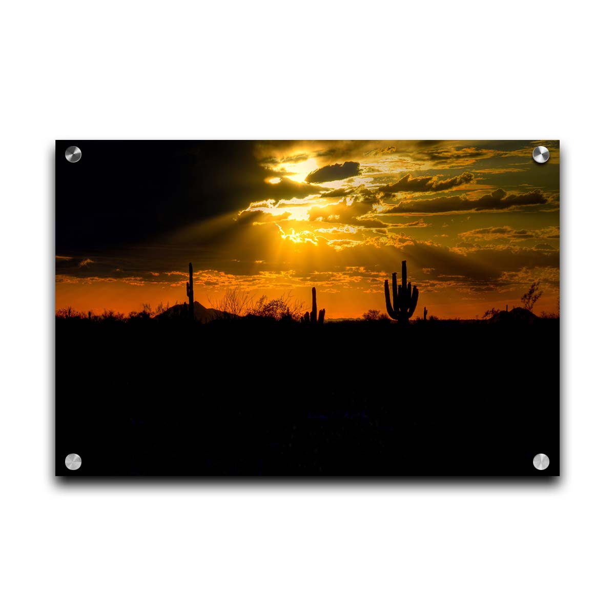 A photo of a sunset over the desert in Arizona, the landscape shadowed in black against the orange and yellow sky. Printed on acrylic.