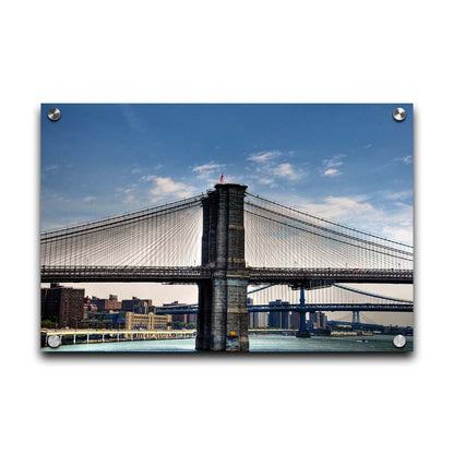 A photo of a side view of the Brooklyn Bridge against a blue sky. Printed on acrylic.