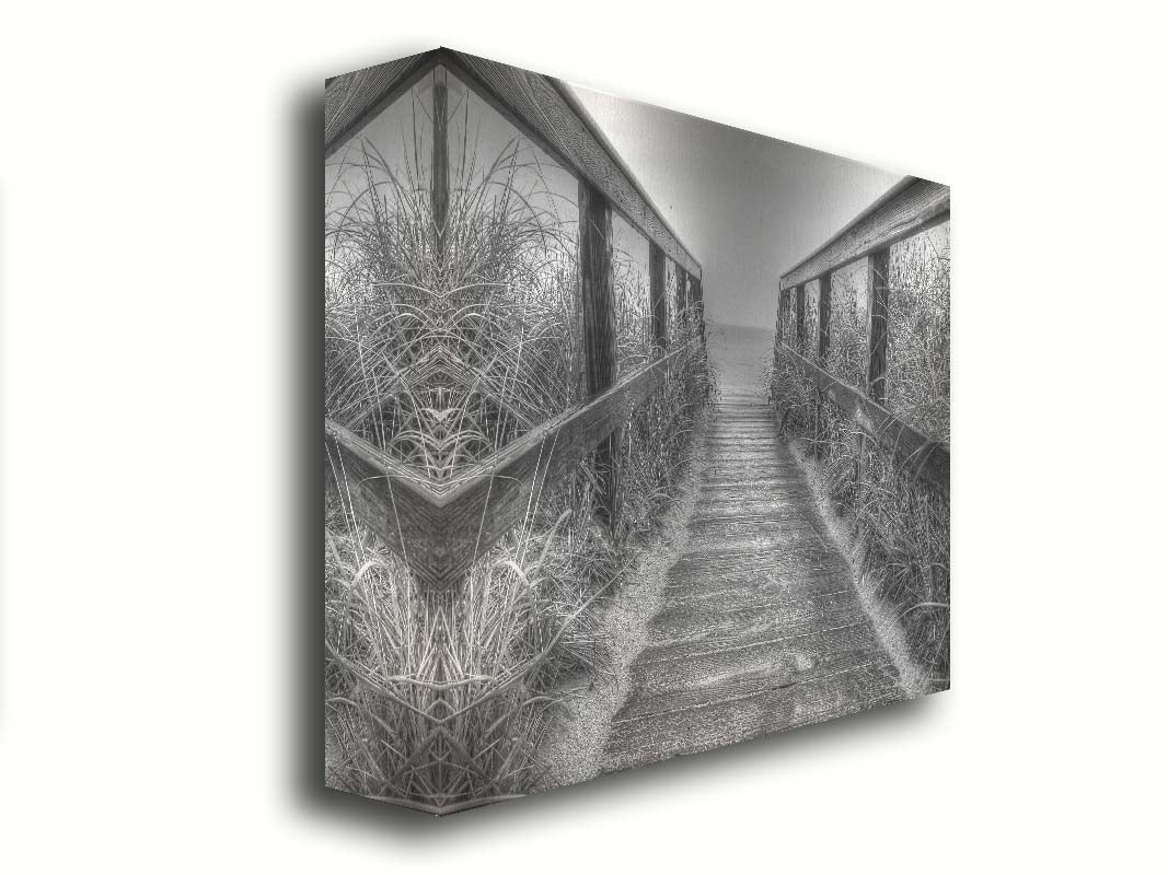 A grayscale photo looking down a wooden railed path on the beach at Cape Cod. Printed on canvas.