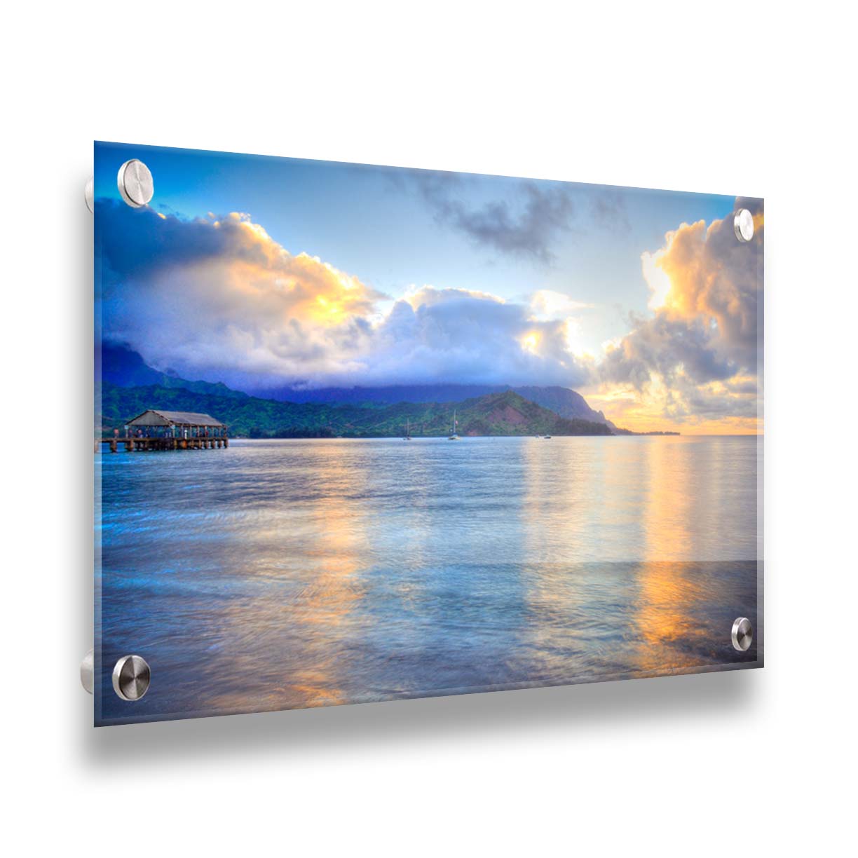 A photo of the ocean at Hanalei Bay at sunset. Clouds rest atop the mountains and reflect the golden light. Printed on acrylic.