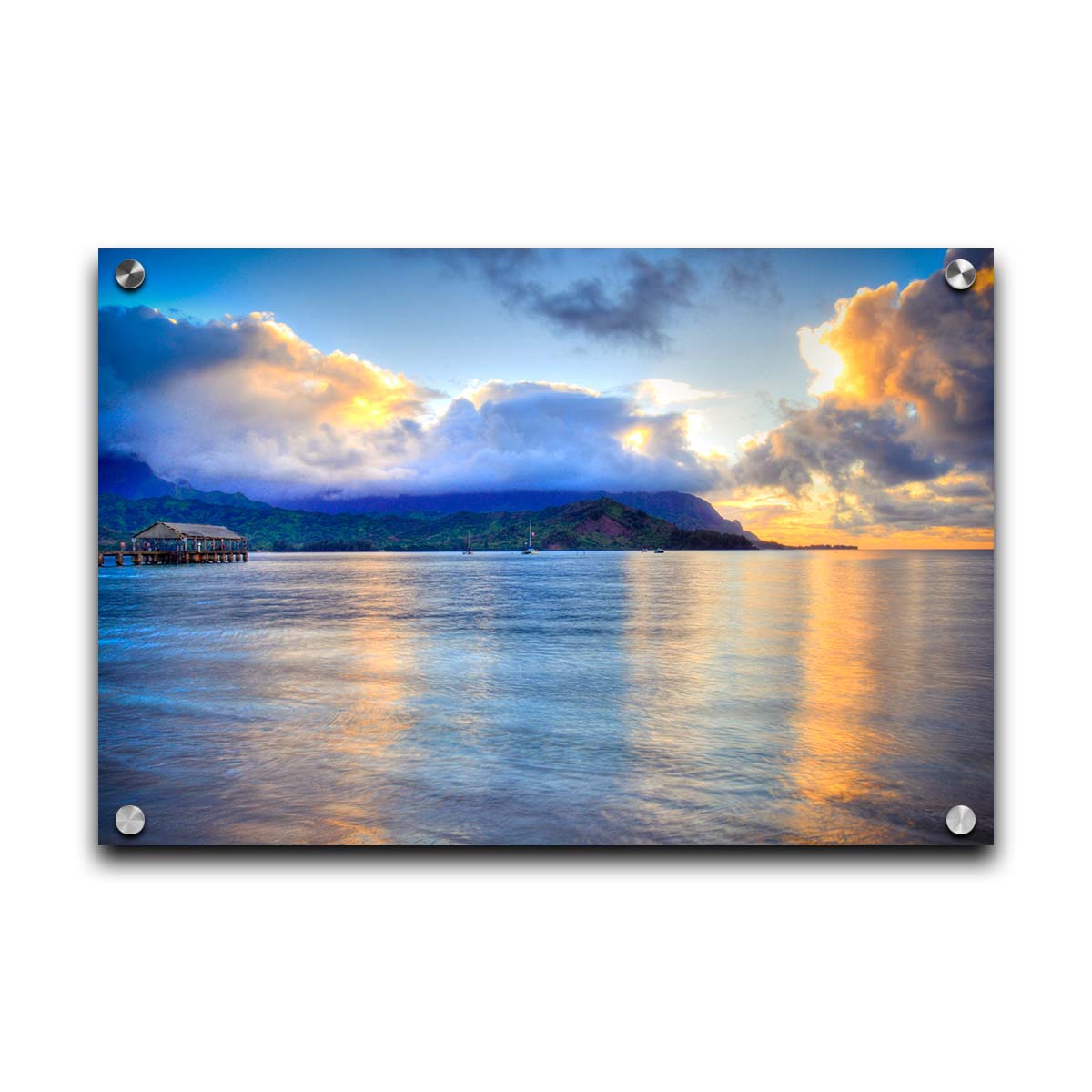 A photo of the ocean at Hanalei Bay at sunset. Clouds rest atop the mountains and reflect the golden light. Printed on acrylic.