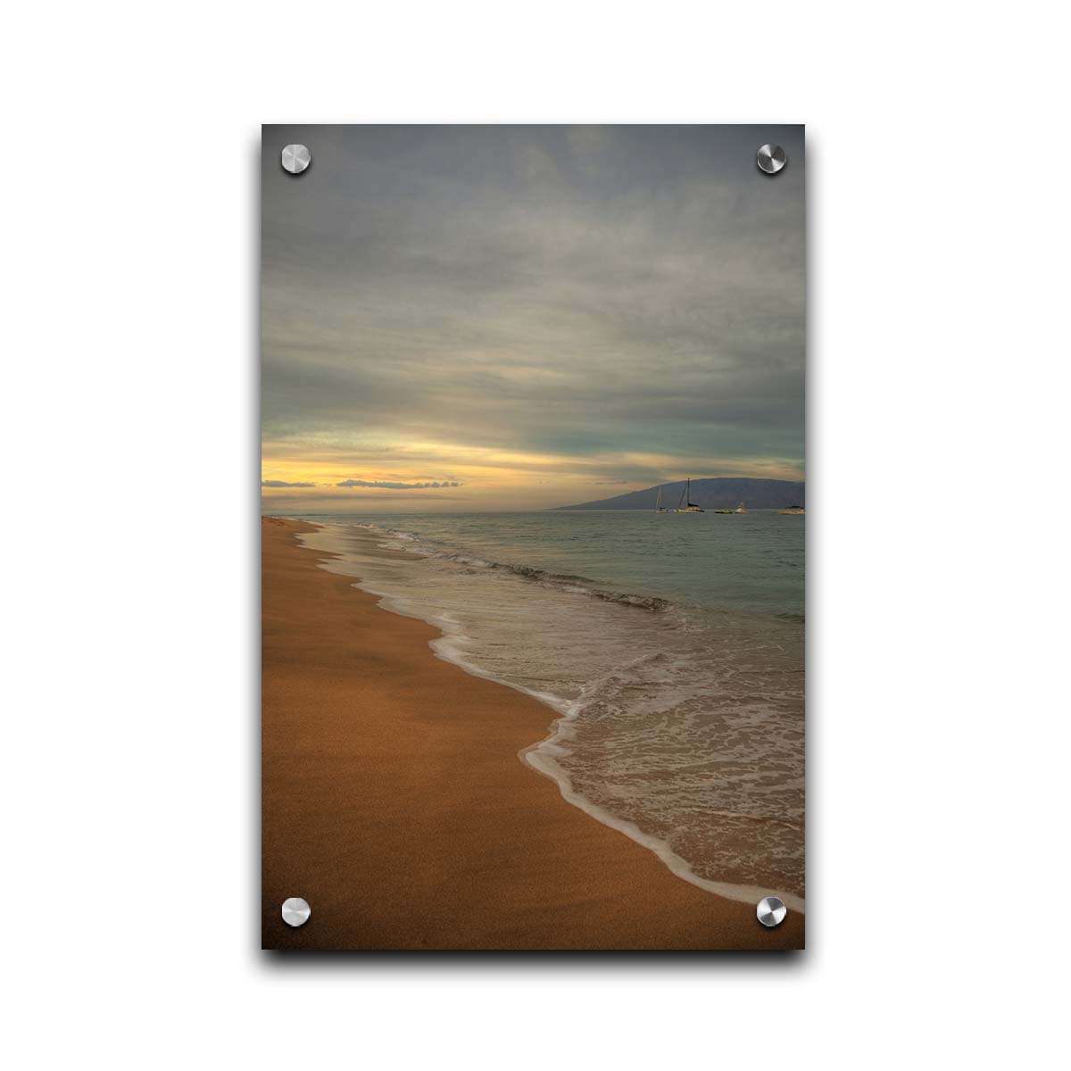 A photo of a cloudy sunrise on the Kaʻanapali shore, looking out to sea. Sailboats can be seen out on the water. Printed on acrylic.