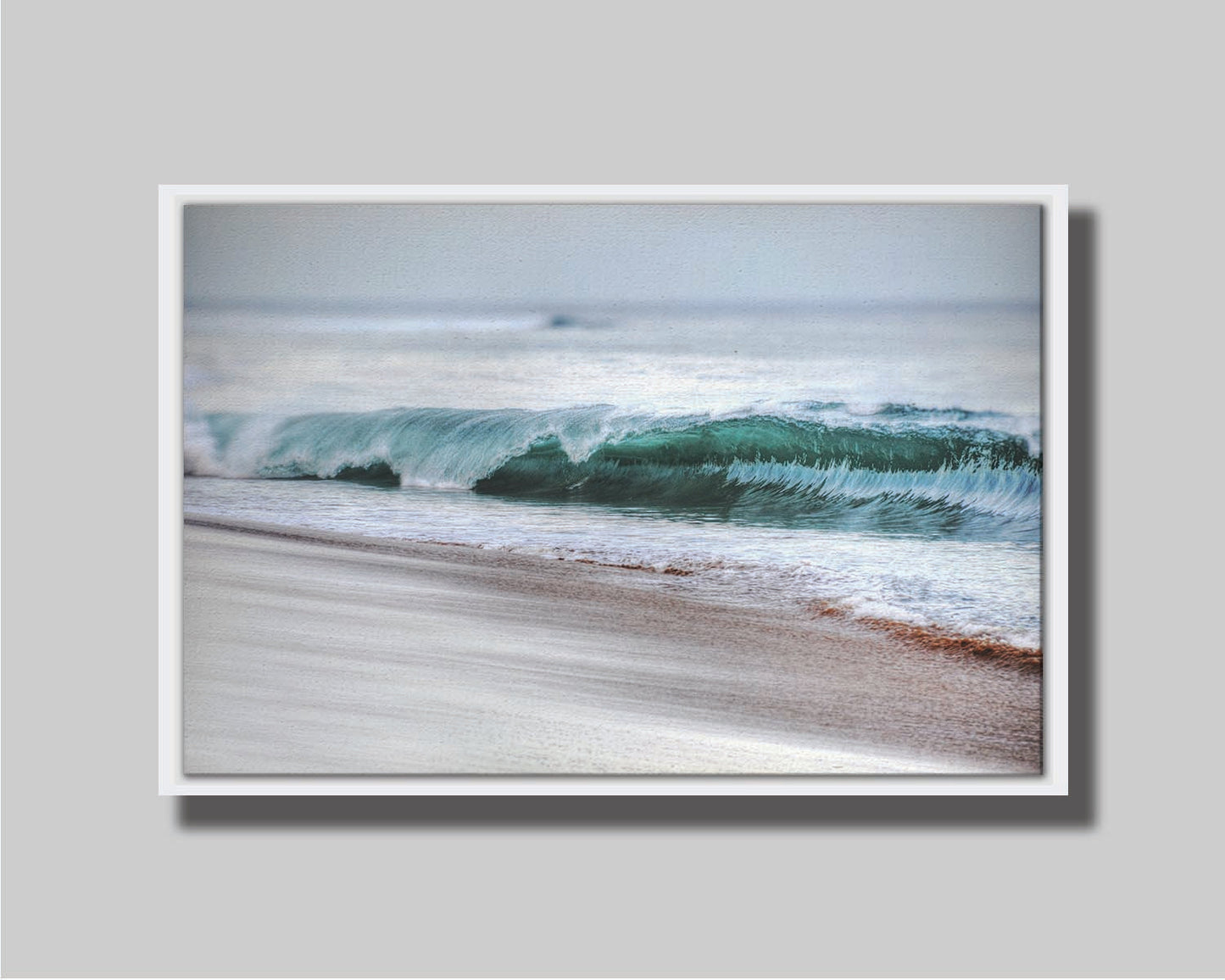 A photo closeup of a wave at Kaʻanapali, the gentle morning light shining through the water to create a beautiful blue-green. Printed on canvas in a float frame.