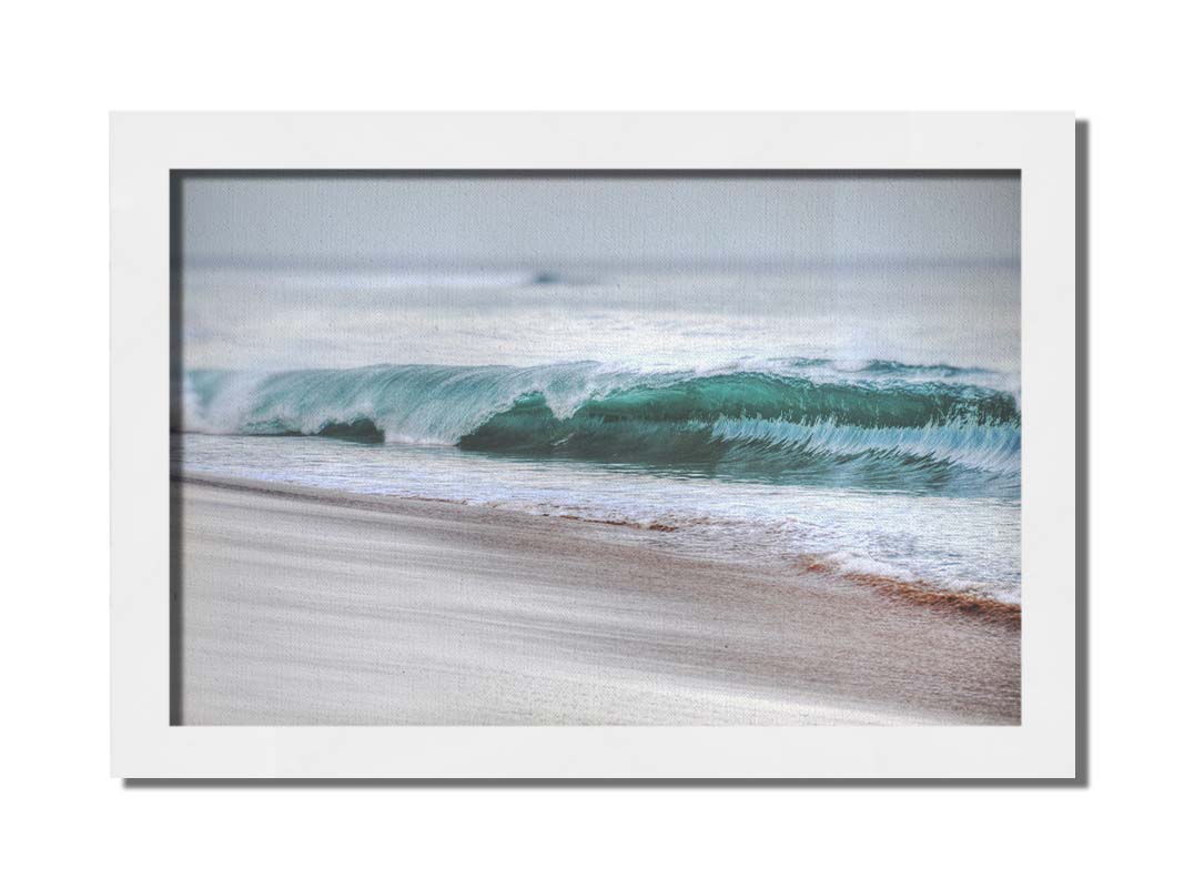 A photo closeup of a wave at Kaʻanapali, the gentle morning light shining through the water to create a beautiful blue-green. Printed on canvas and framed.