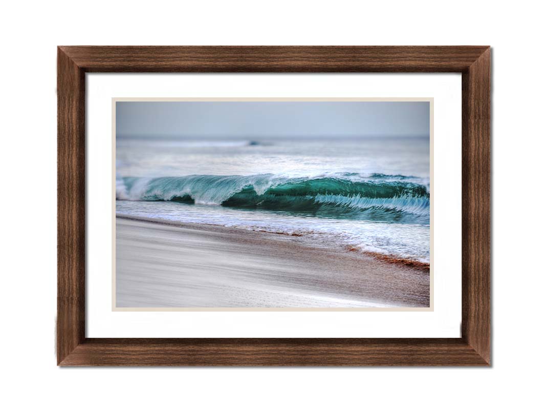 A photo closeup of a wave at Kaʻanapali, the gentle morning light shining through the water to create a beautiful blue-green. Printed on paper, matted, and framed.