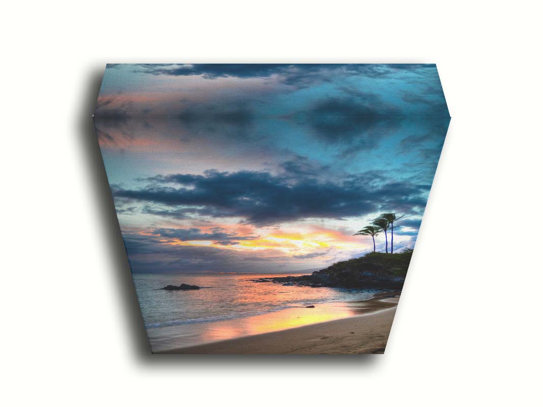 A photo of the sunset at Honokahua, Maui peeking through the clouds and reflecting pink and orange on the water. Palms are silhouetted against the sky. Printed on canvas.