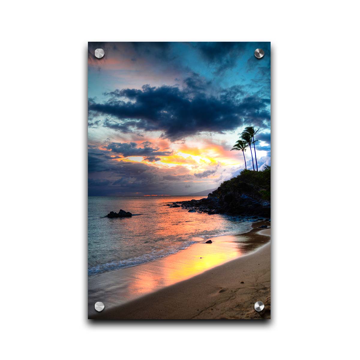 A photo of the sunset at Honokahua, Maui peeking through the clouds and reflecting pink and orange on the water. Palms are silhouetted against the sky. Printed on acrylic.