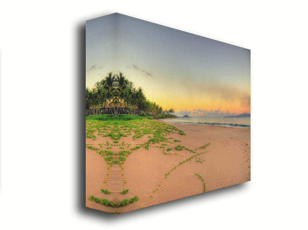 A photo of Keawakapu Beach at sunrise, with palms and mountains in the distance. Printed on canvas.