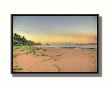 A photo of Keawakapu Beach at sunrise, with palms and mountains in the distance. Printed on canvas in a float frame.