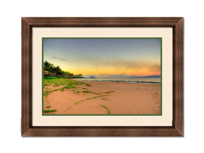 A photo of Keawakapu Beach at sunrise, with palms and mountains in the distance. Printed on paper, matted, and framed.