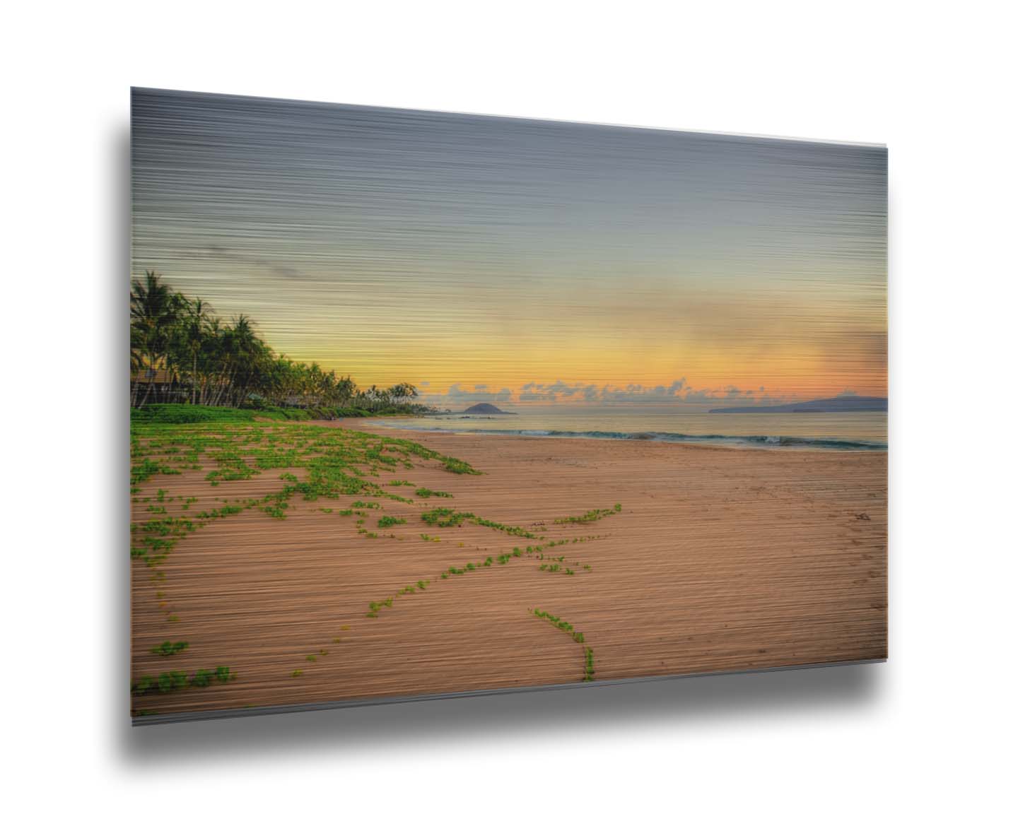 A photo of Keawakapu Beach at sunrise, with palms and mountains in the distance. Printed on metal.