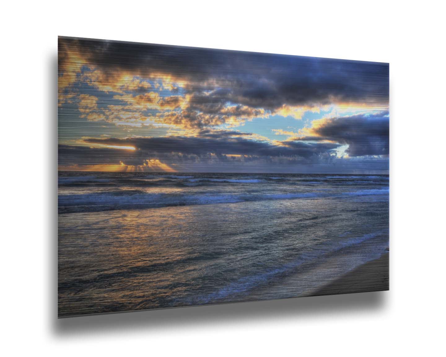 A photo looking out to sea off the coast of Kauaʻi at sunrise. The sunlight reflects off the sea and clouds in a beautiful parallel. Printed on metal.